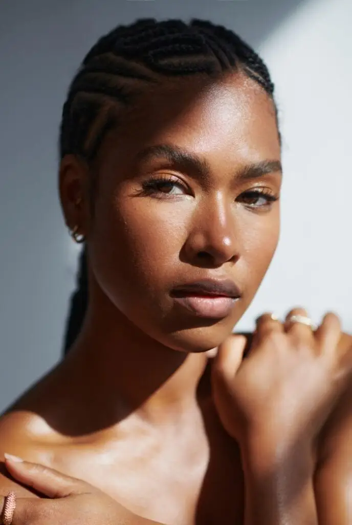 Glowing black woman skin with Glow mama approved skincare products for moms. Best skincare for busy moms