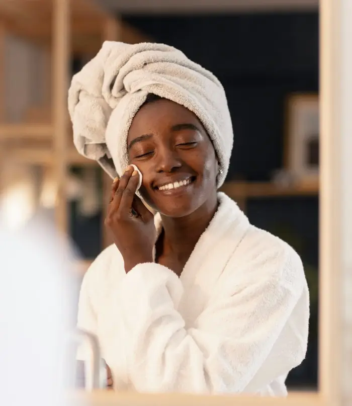 mom doing selfcare beauty treatments Glowing black woman skin with Glow mama approved skincare products for moms. Best skincare for busy moms